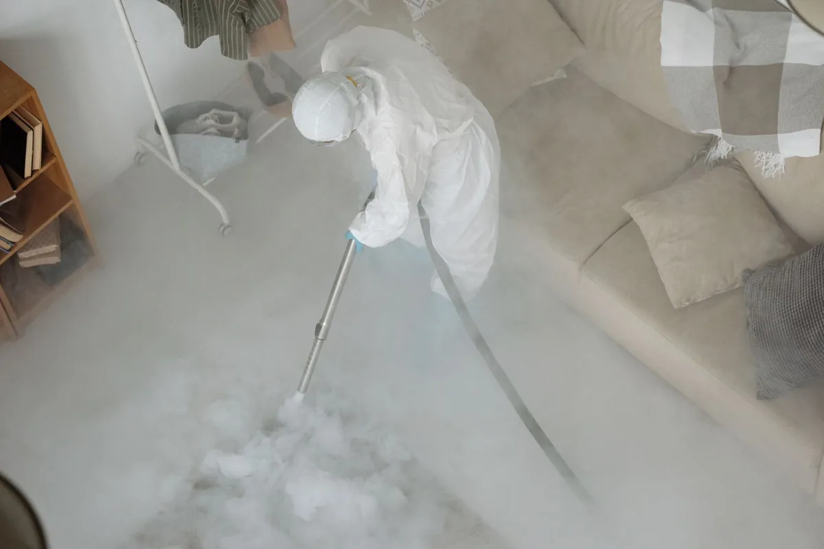 Biohazard cleanup technician in protective equipment, Comanche, TX